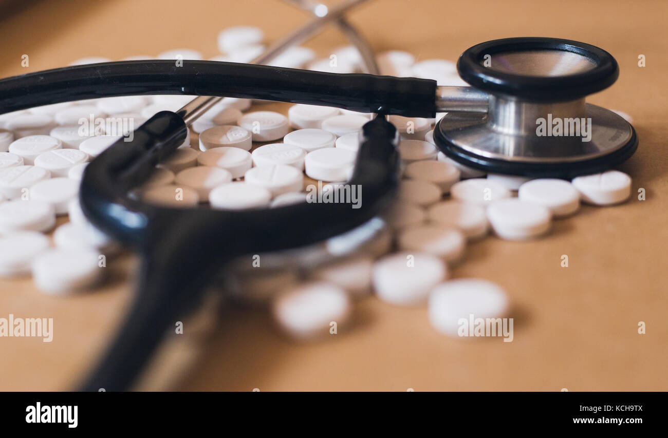 Health Stethoscope on white medicine tablets Stock Photo - Alamy