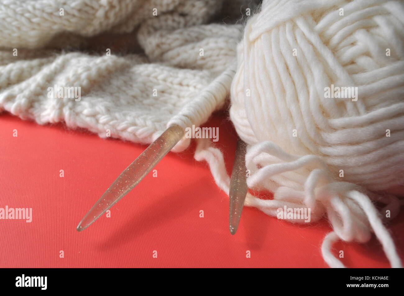 White sheep wool yarn being made into a knitted handmade wearable