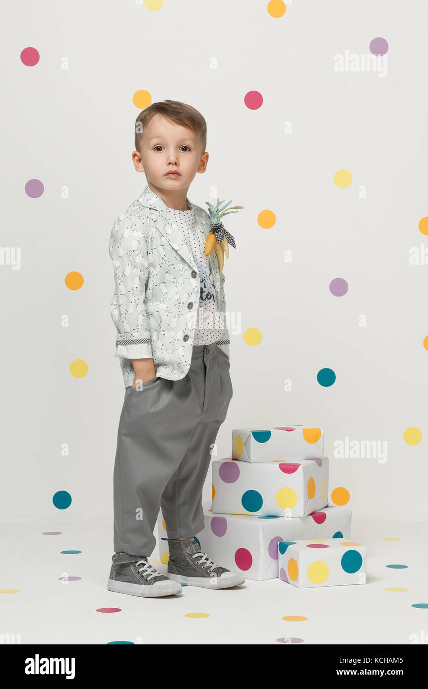 little boy in the trendy and designer suits and sneakers on a white background Stock Photo