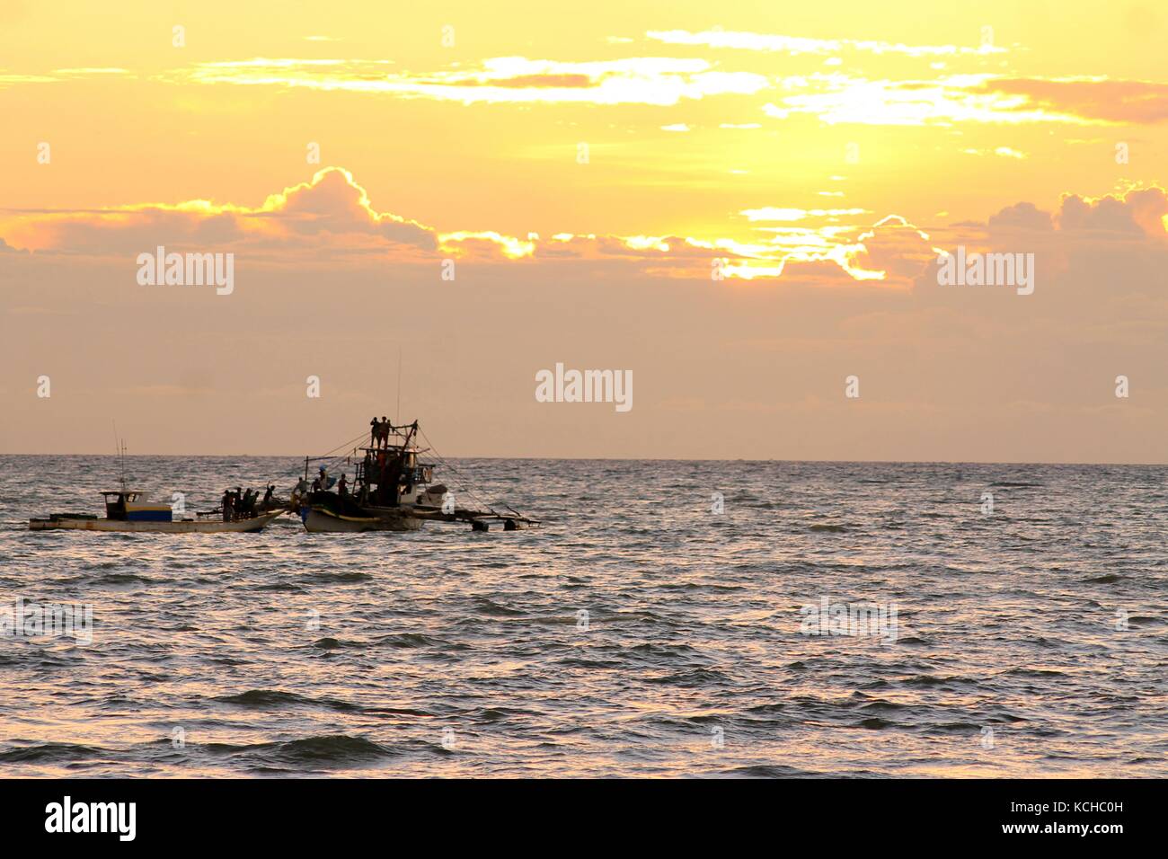Silhouettes of fishermen in the sunset Stock Photo - Alamy