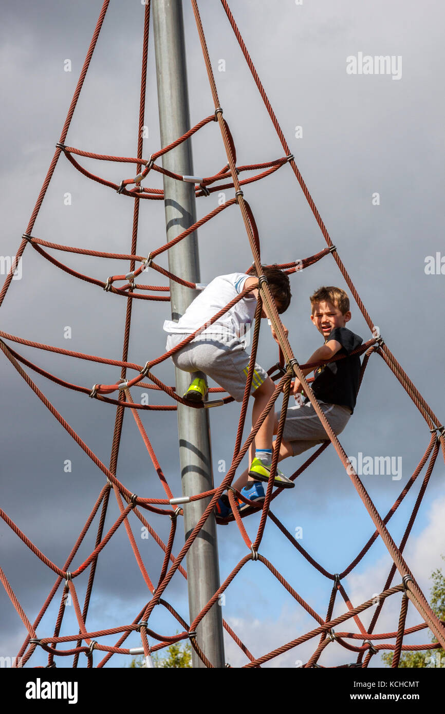 Young Boys climbing Apparatus in Playground Stock Photo