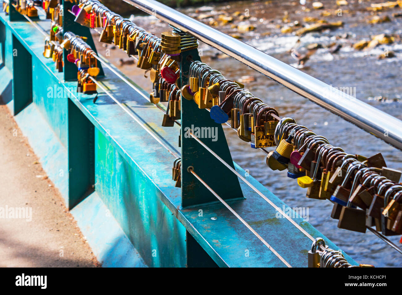 Love Locks on footbridge over River Wye, Bakewell, close-up Stock Photo