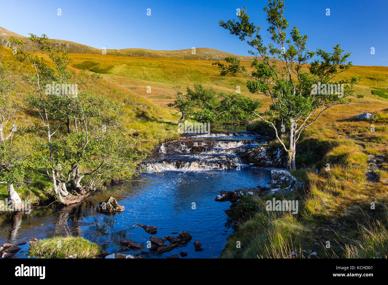 Stream in the highlands of Scotland fowing across moorland Stock Photo