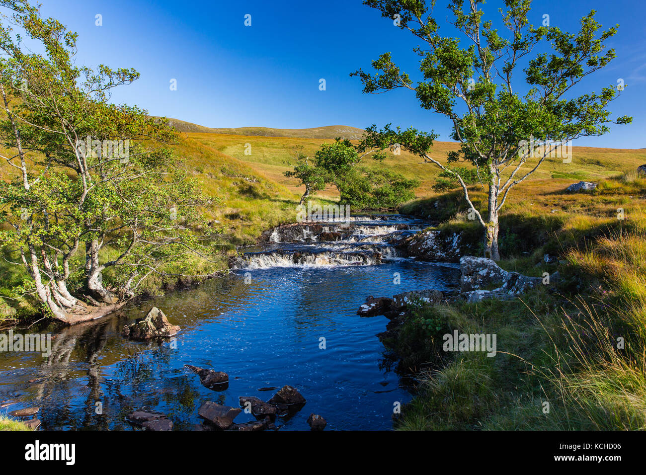 Stream in the highlands of Scotland fowing across moorland Stock Photo