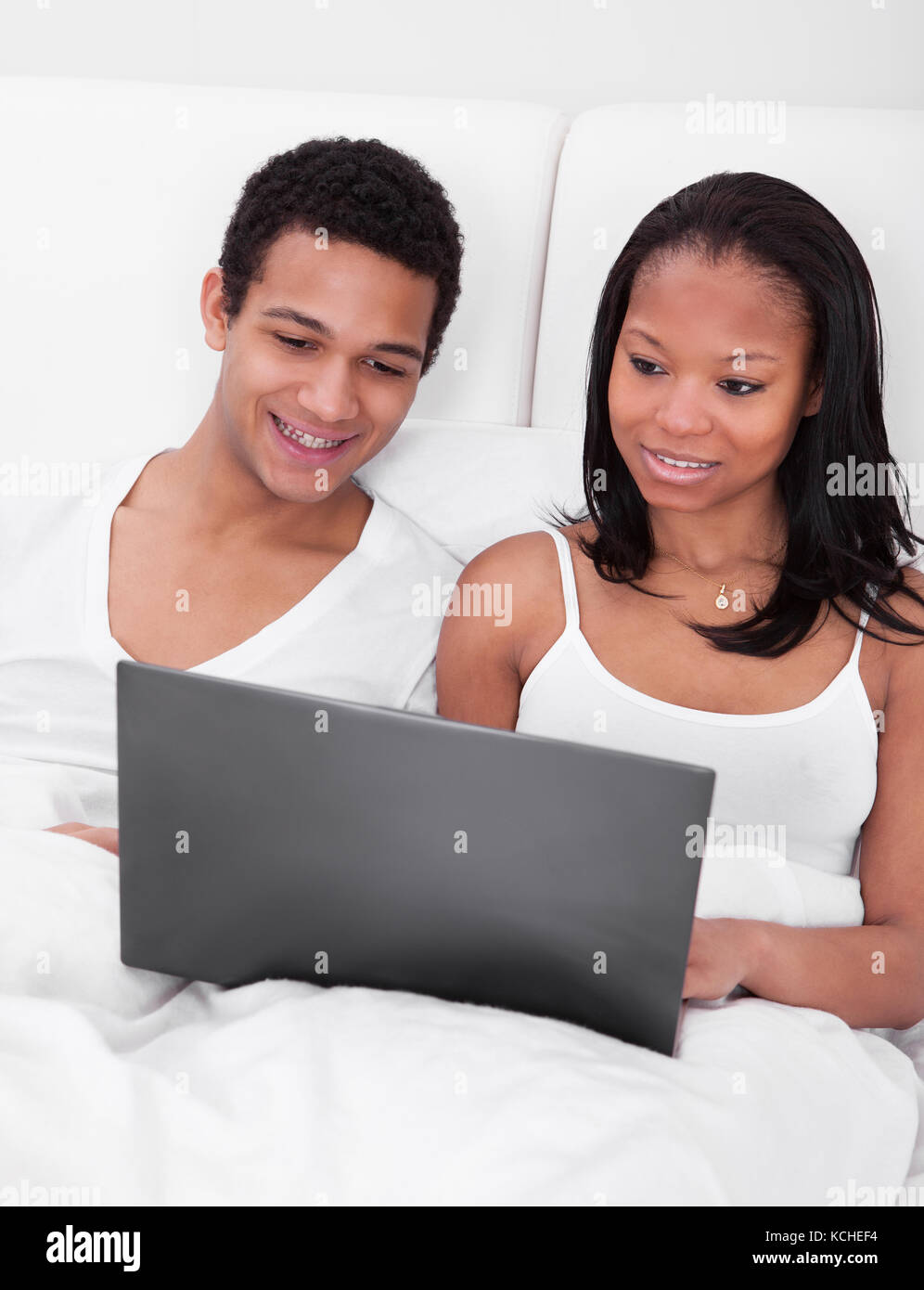 Portrait Of Young African Couple Looking At The Laptop Stock Photo - Alamy