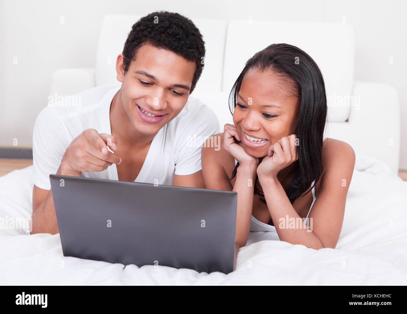 Portrait Of Young Couple Looking At The Laptop Stock Photo - Alamy