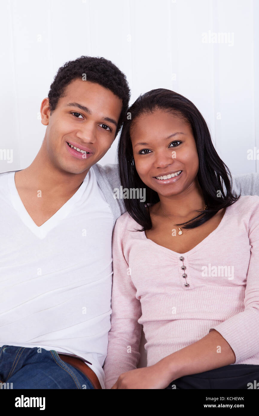 Portrait Of Happy Young Couple At Home Smiling Stock Photo - Alamy