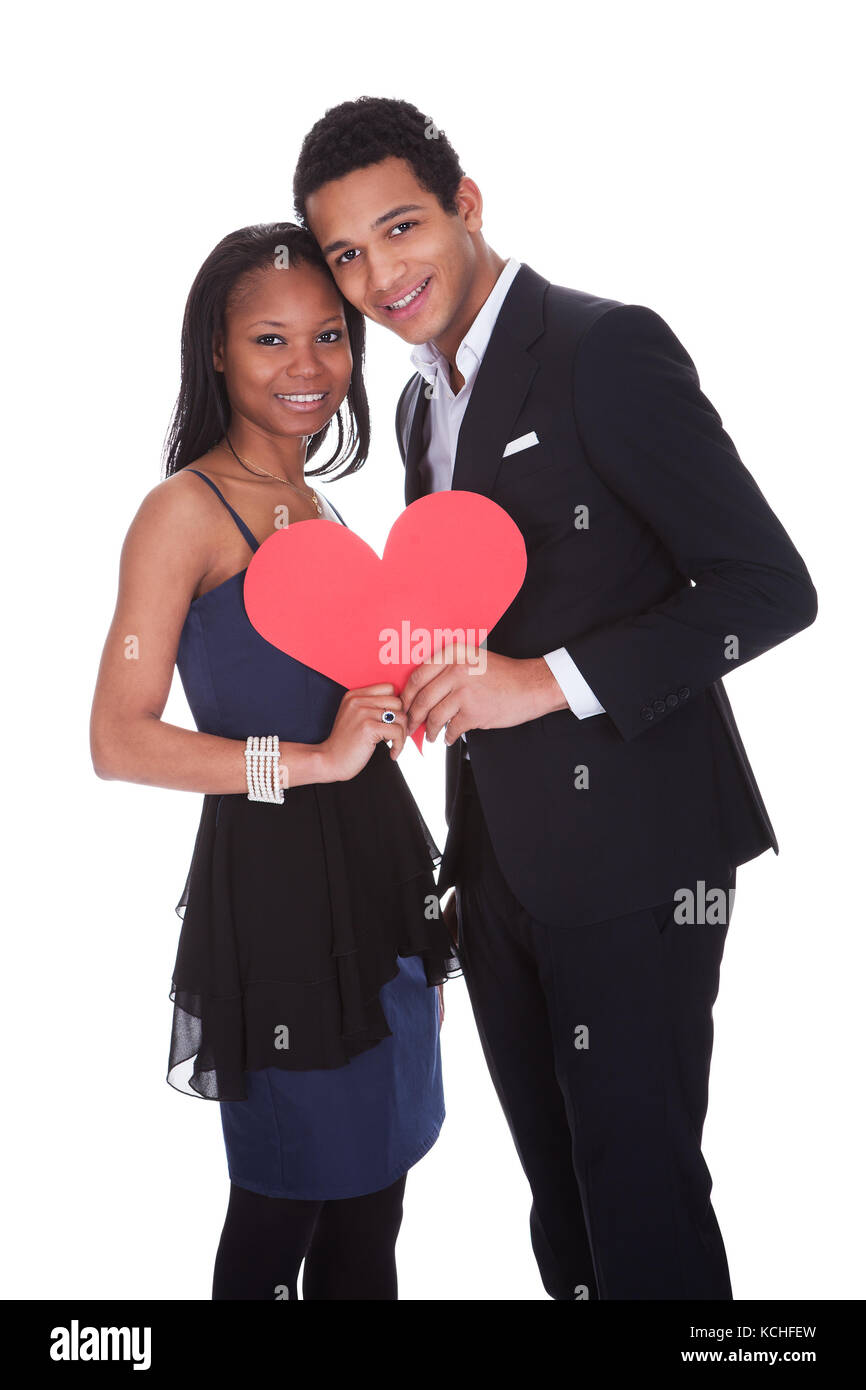 Portrait Of African Couple Holding Heart Over White Background Stock ...