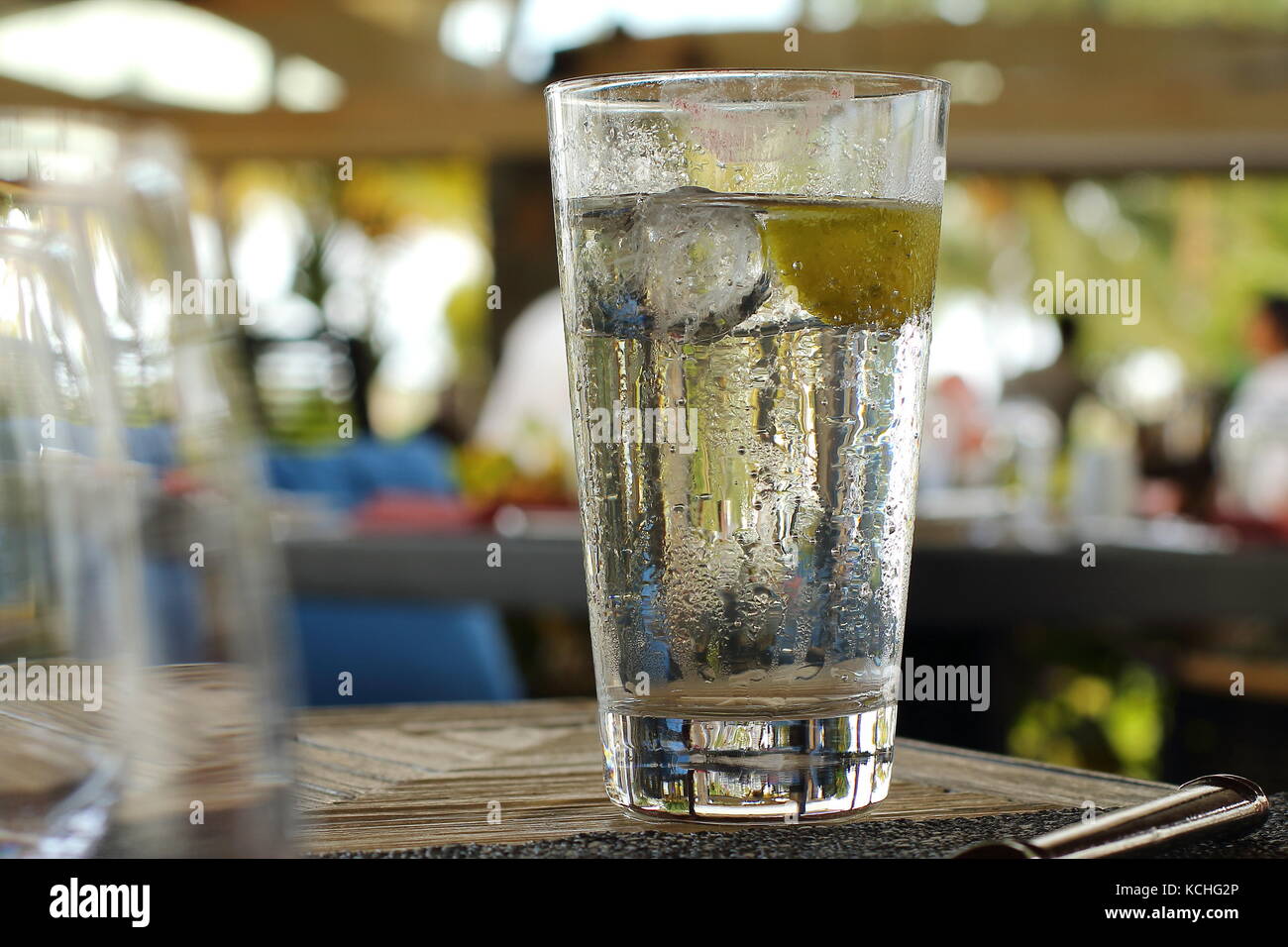 Ice cold drink with condensation droplets on the side of the glass in landscape format Stock Photo