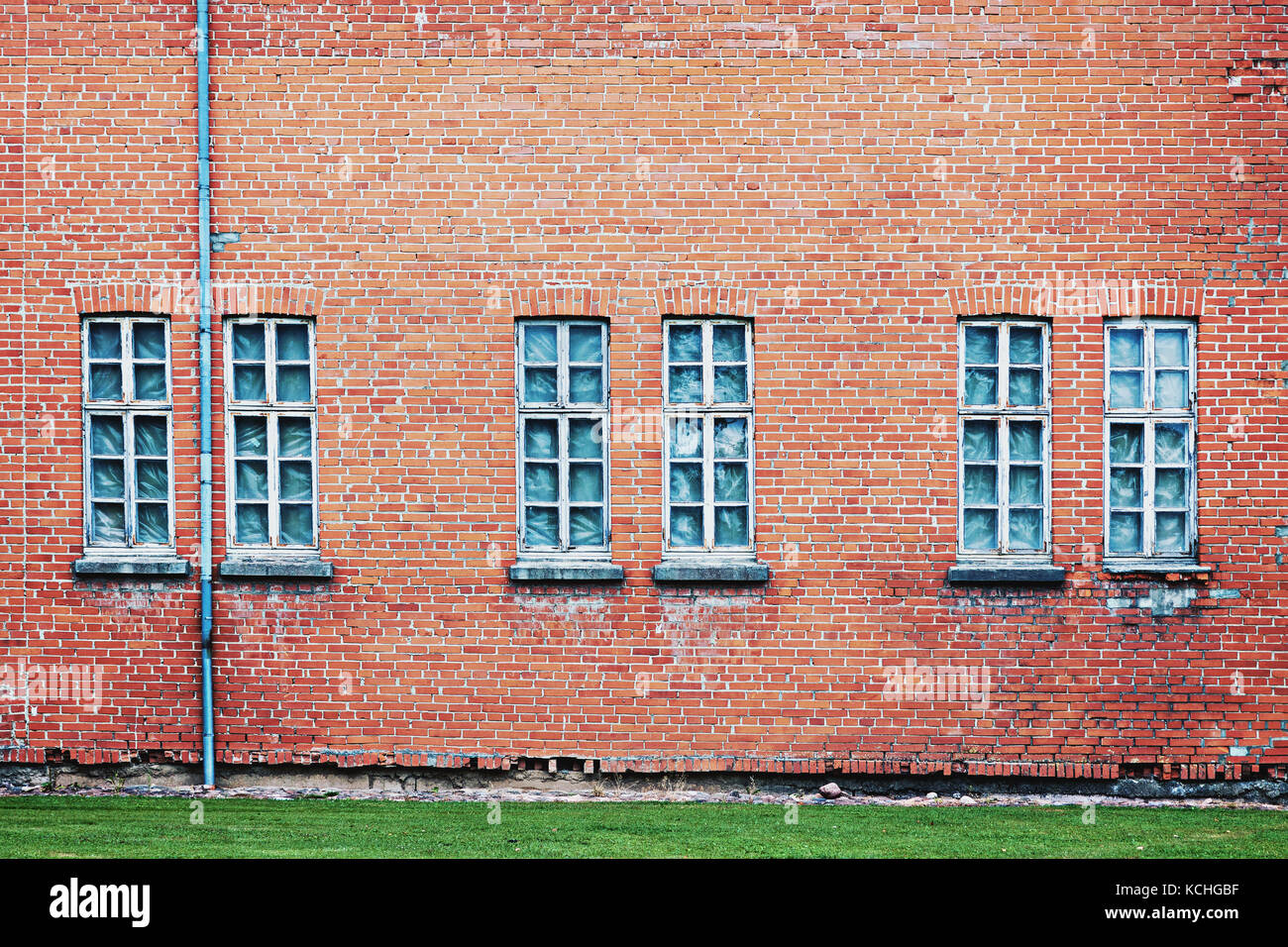 Abandoned architecture background with old weathered brick wall and group of windows Stock Photo