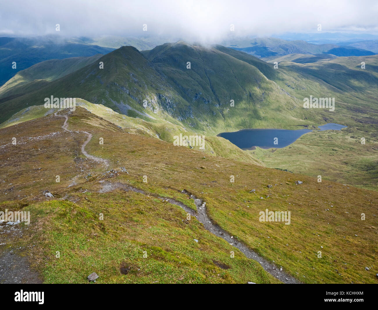 View from Ben Lawers summit to Lochan nan Cat and the peaks of An Stuc and Meall Garbh, Perthshire, Scotland Stock Photo