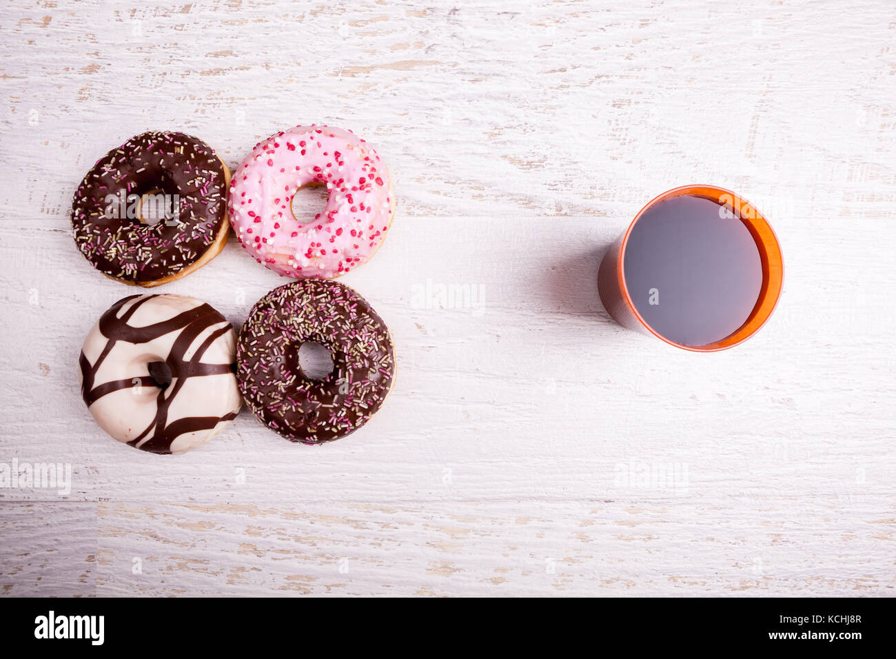 Different type of donuts on white wooden background Stock Photo - Alamy