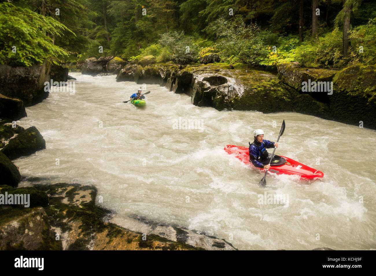 Two adventurous kayakers on the first descent of the Incomappleux River, BC Stock Photo
