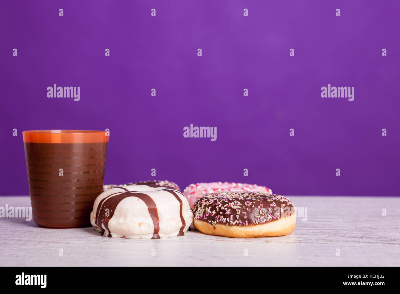 Different type of donuts on white wooden background Stock Photo - Alamy