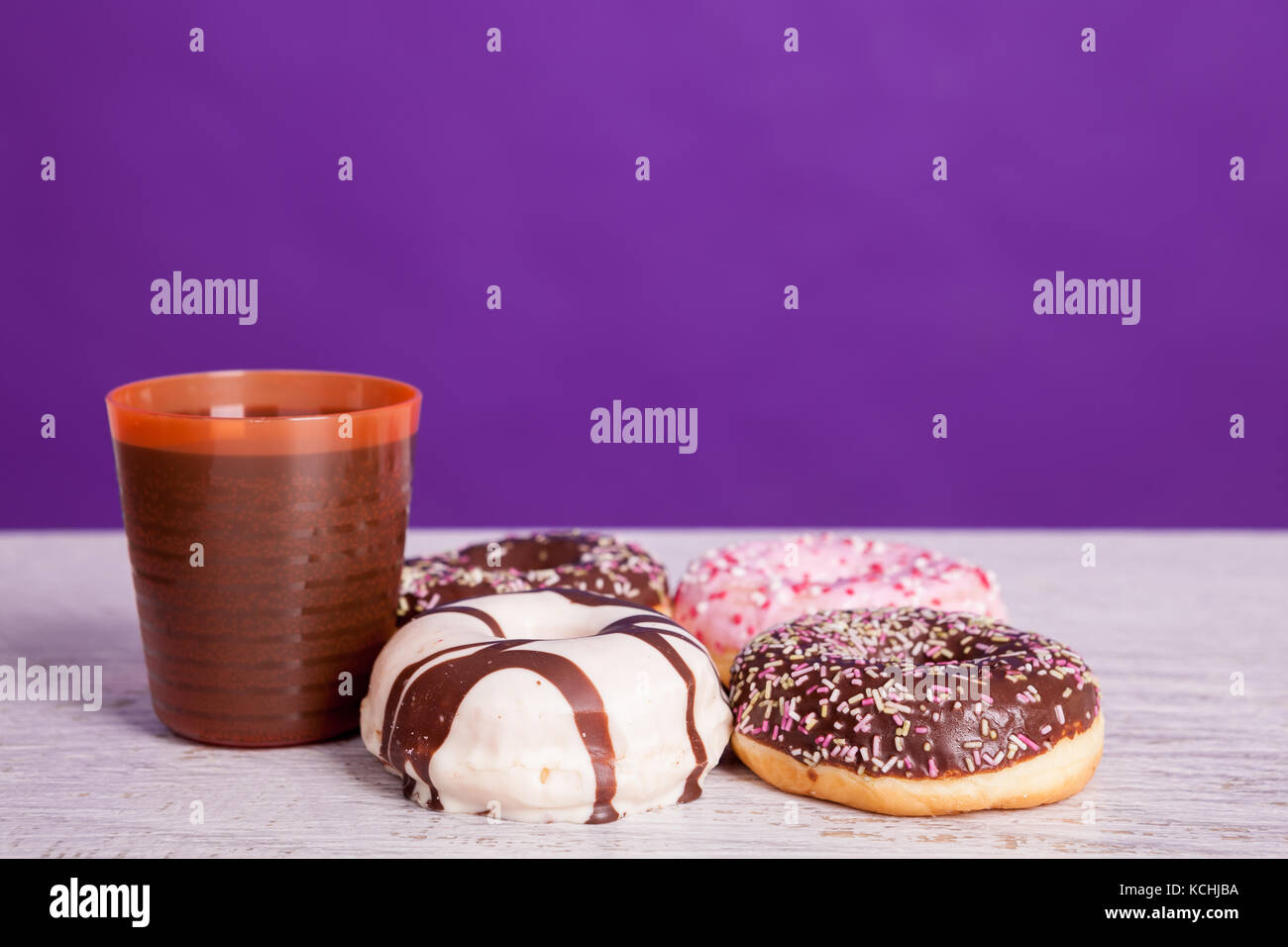 Different type of donuts on white wooden background Stock Photo - Alamy