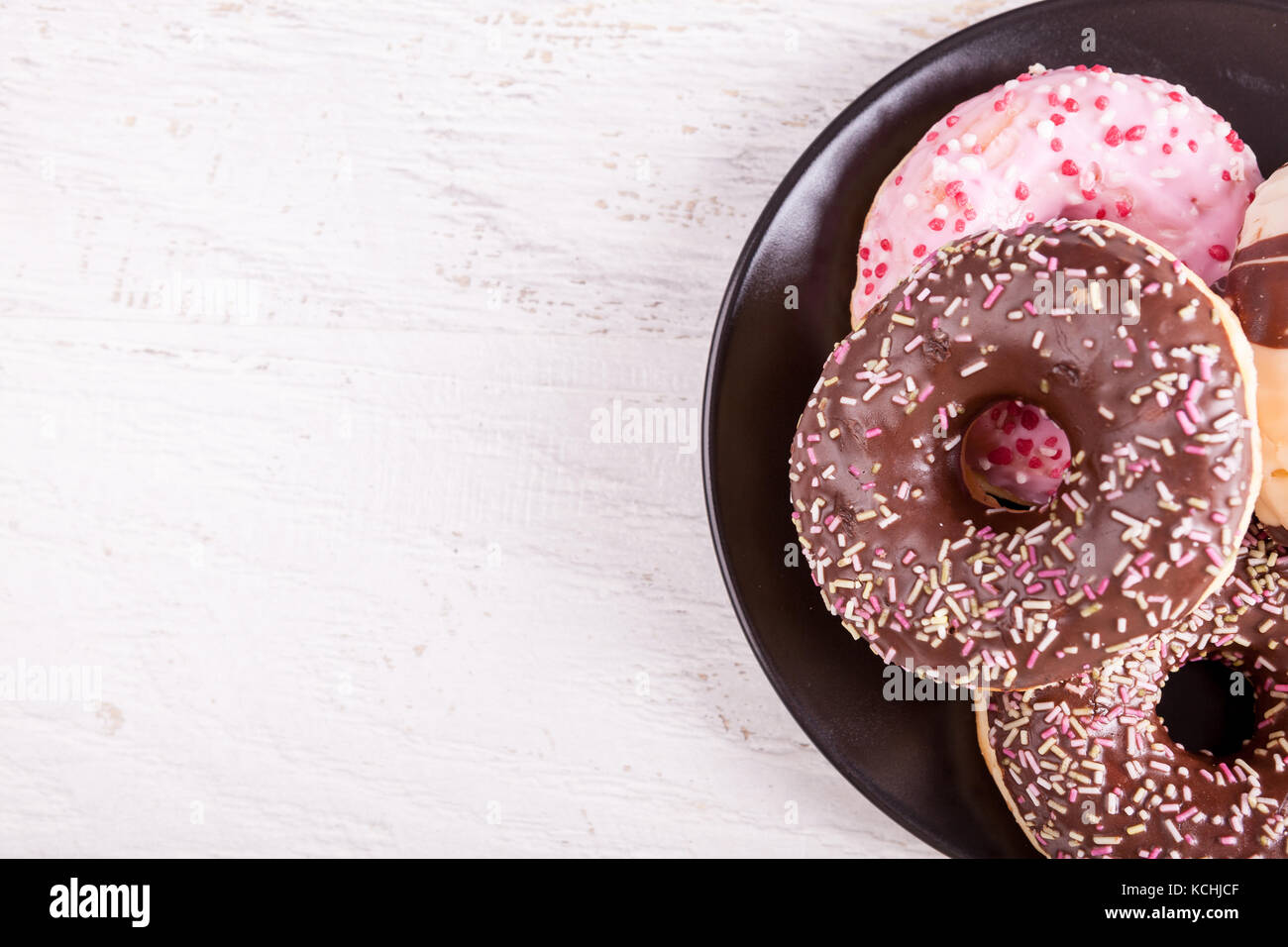 Different type of donuts on white wooden background Stock Photo - Alamy