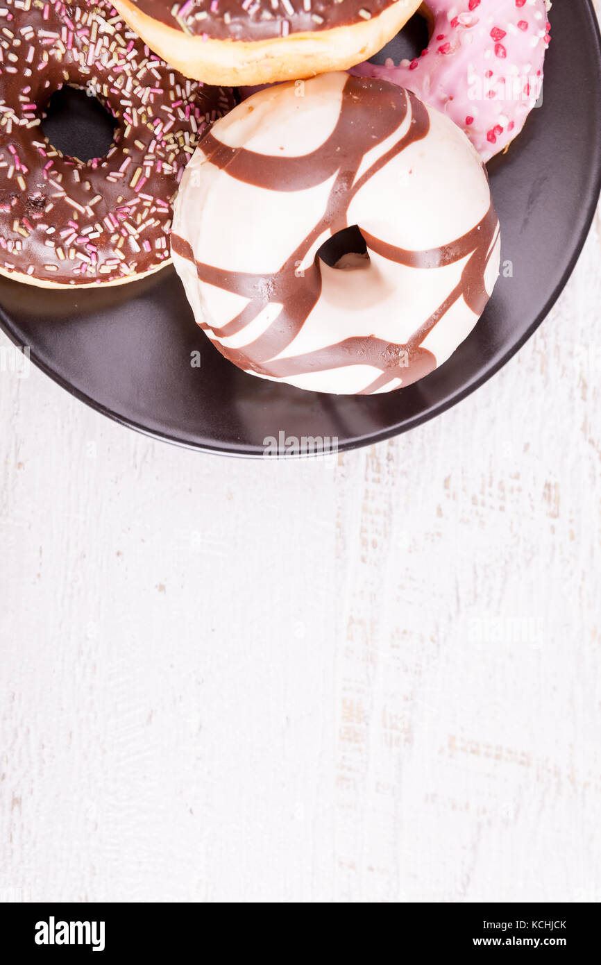 Different type of donuts on white wooden background Stock Photo - Alamy