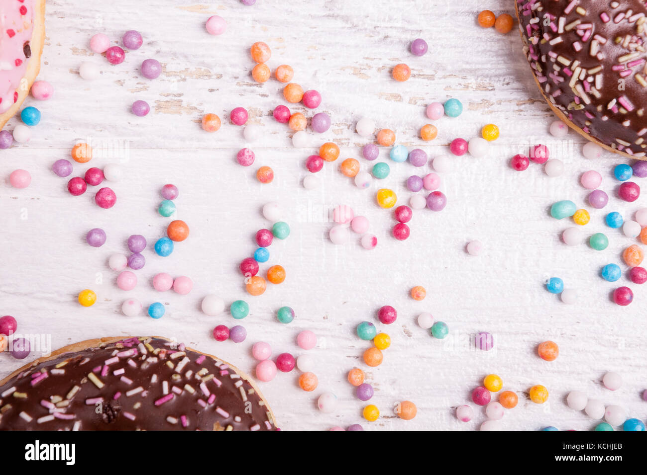 Different type of donuts on white wooden background Stock Photo - Alamy