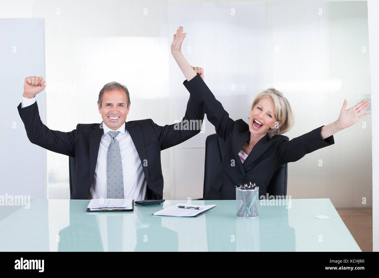Mature Businessman And Businesswoman Enjoying The Success Stock Photo