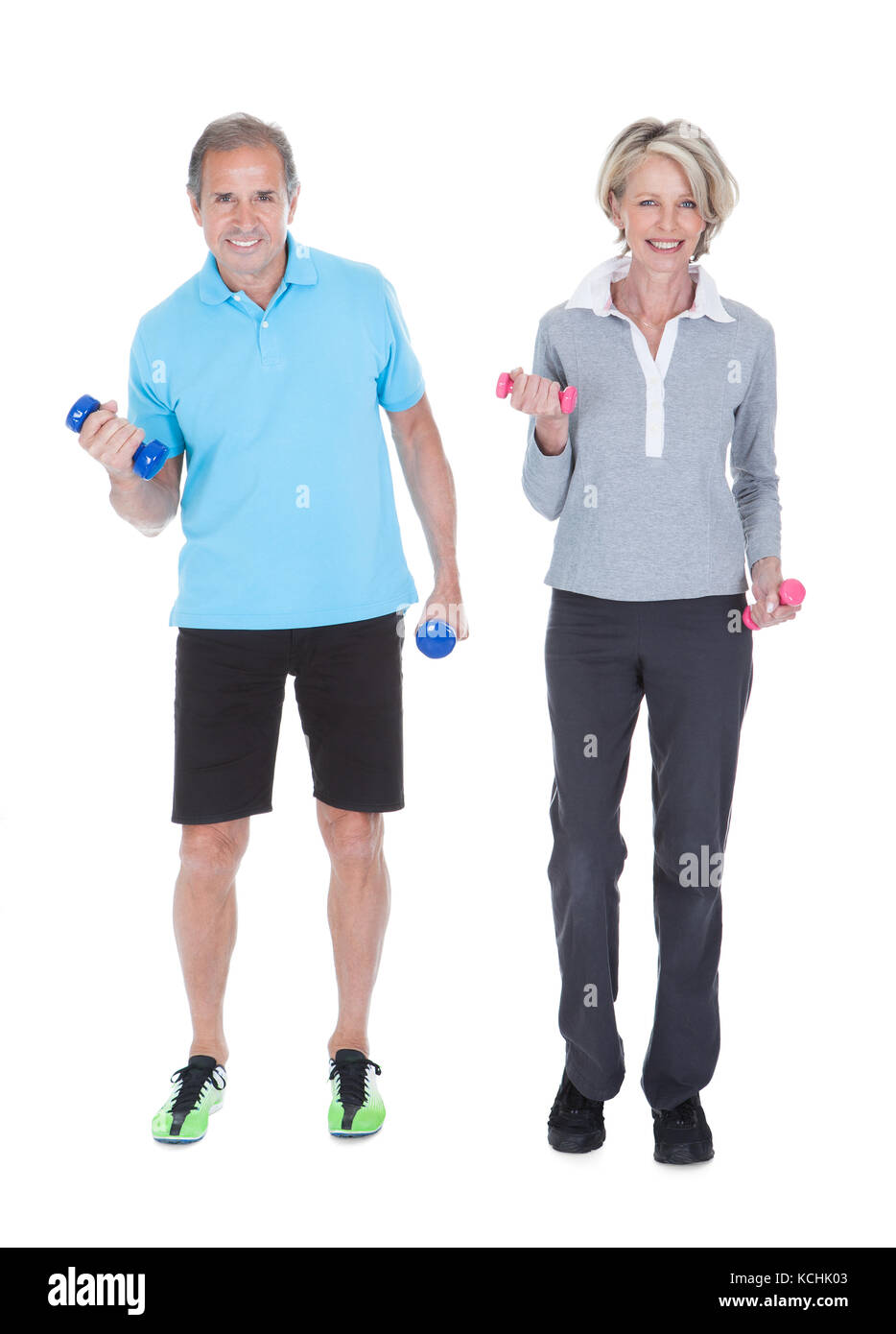 Happy Mature Couple Doing Exercising With Dumbbells Isolated On White Background Stock Photo