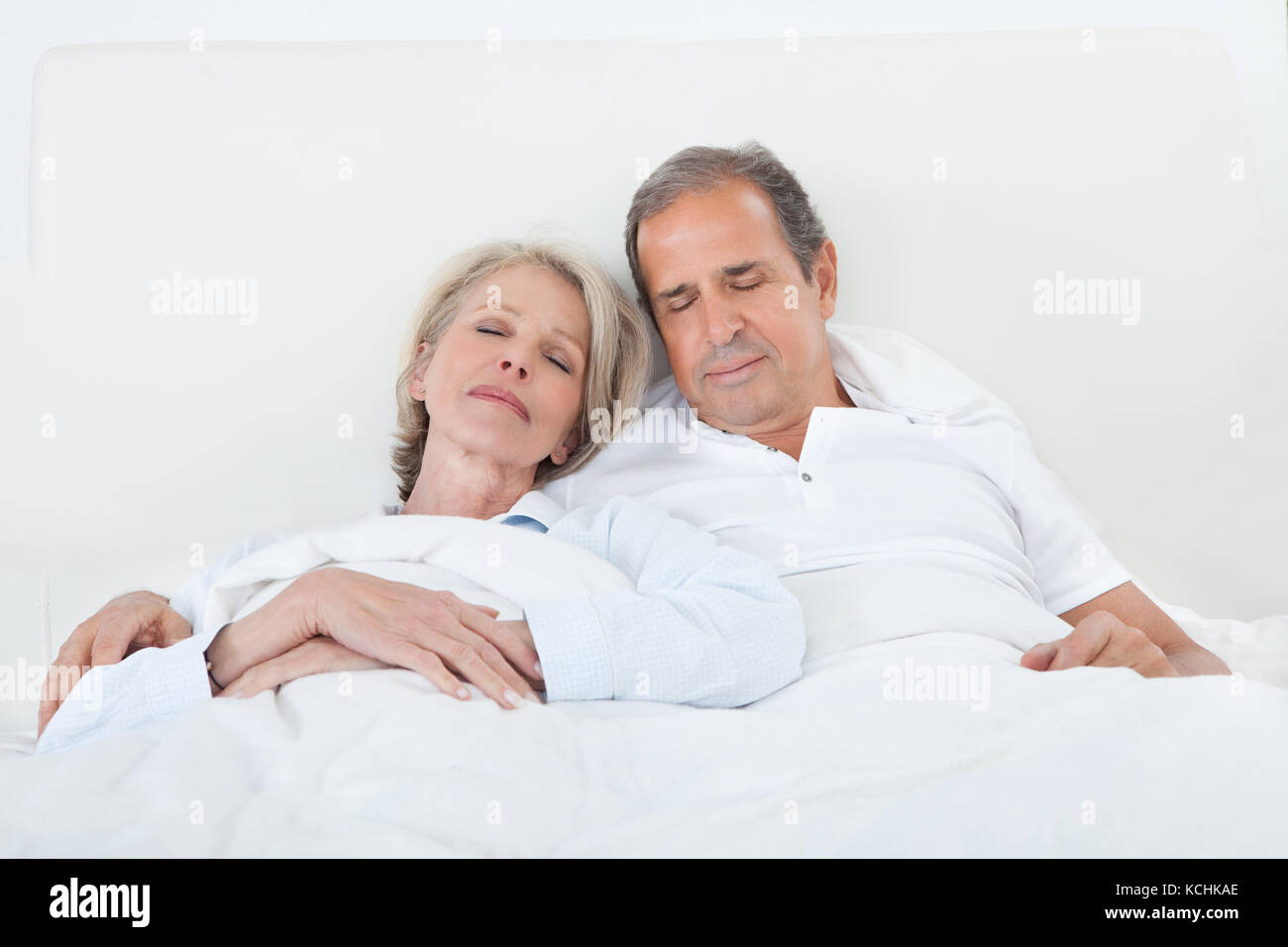 Portrait Of Happy Senior Couple Sleeping Together In Bed Stock Photo ...