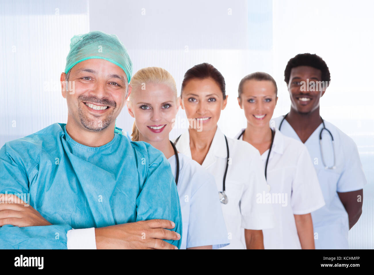 Doctor In Surgical Gown With His Coworkers At The Clinic Stock Photo