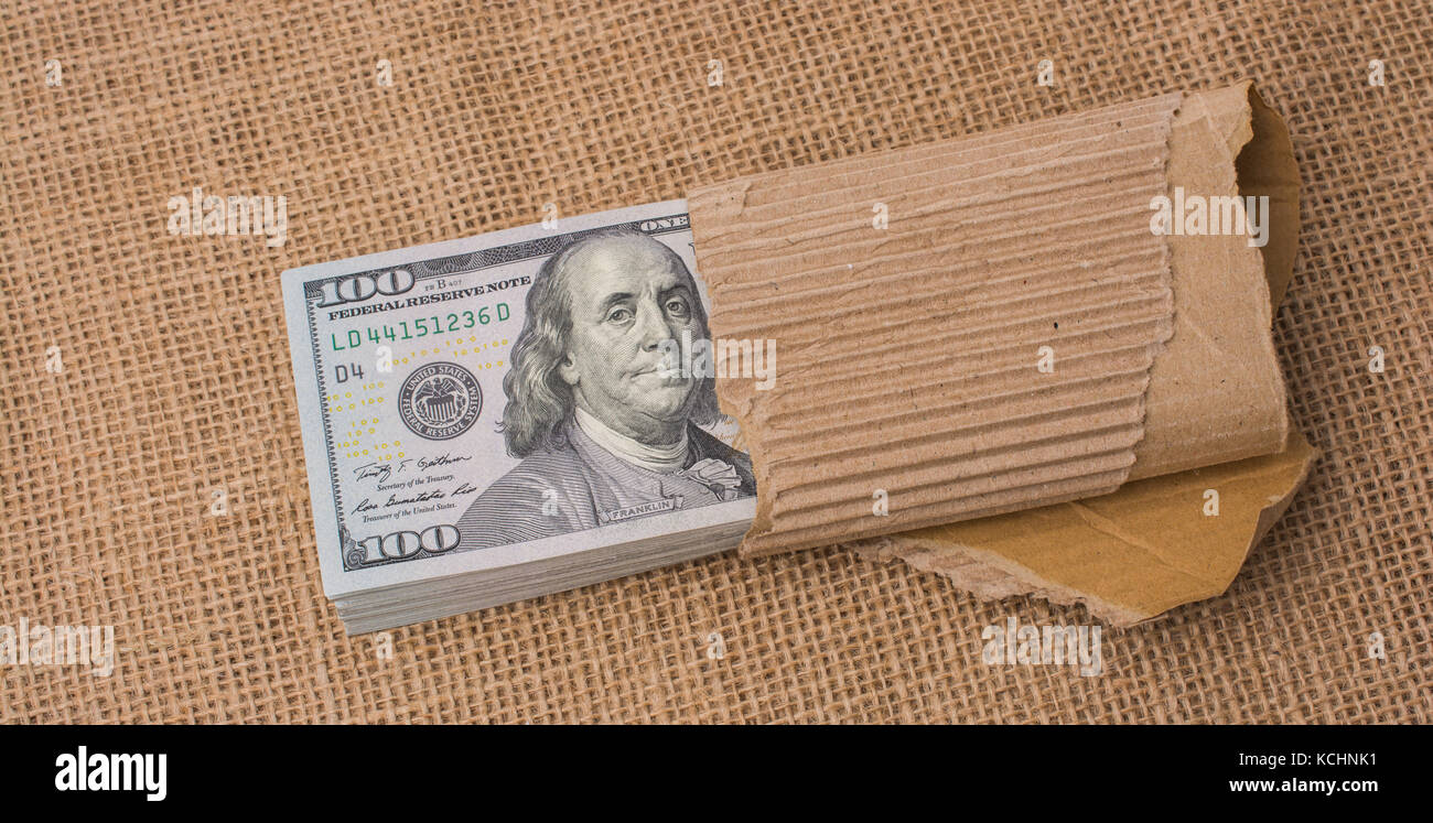 Banknote bundle of US dollar placed on a linen canvas Stock Photo - Alamy