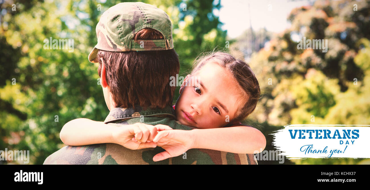 Portrait of sad daughter hugging army man against logo for veterans day in america Stock Photo