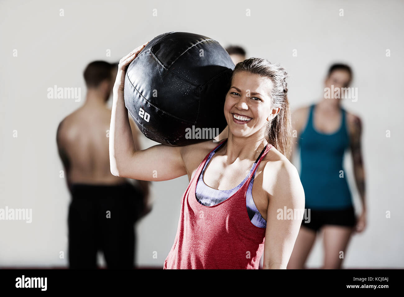 Smiling Female Trainer Carrying Medicine Ball Stock Photo Alamy