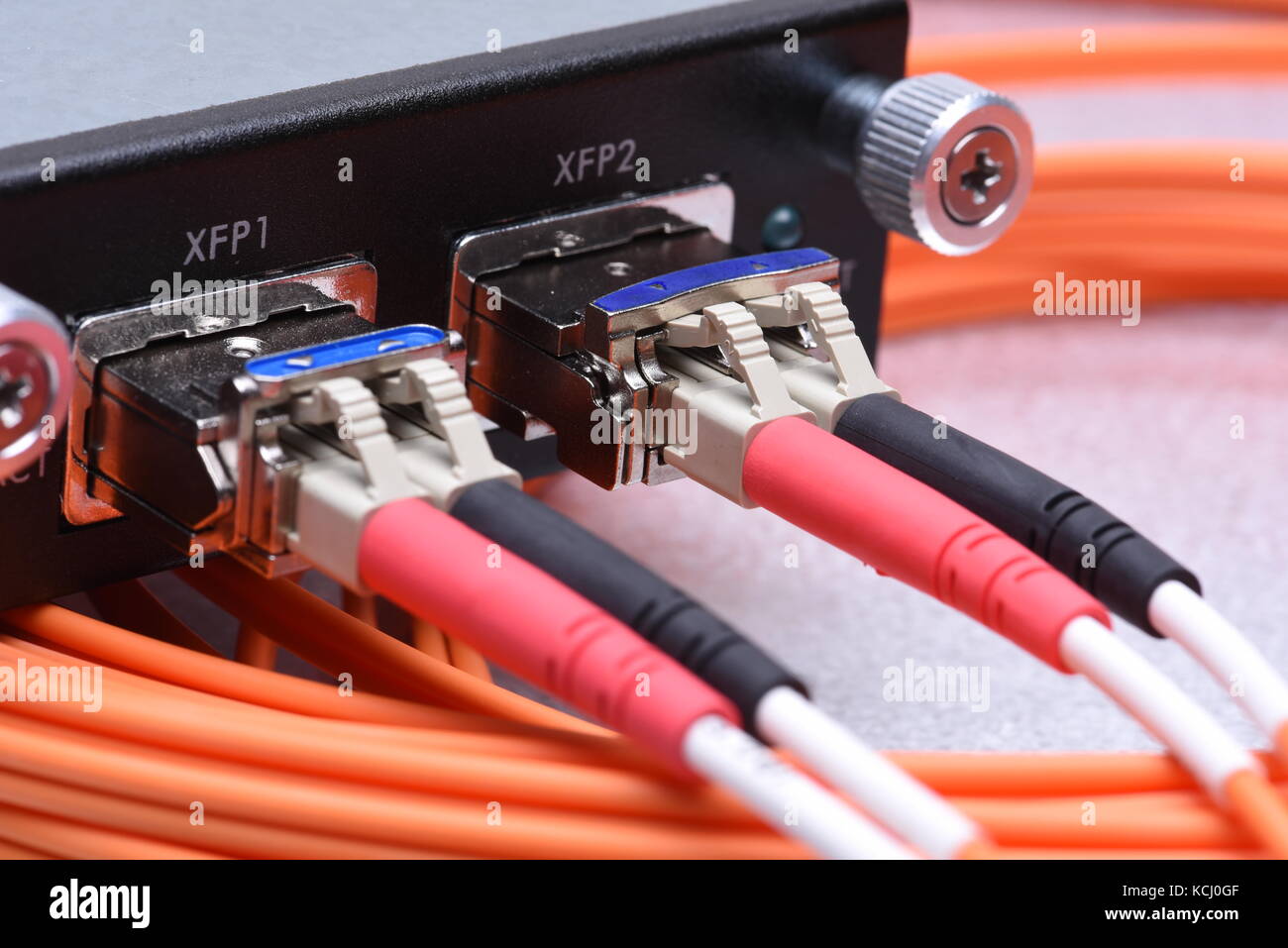 Network optical fiber cables connected to gigabit interface converter Stock Photo
