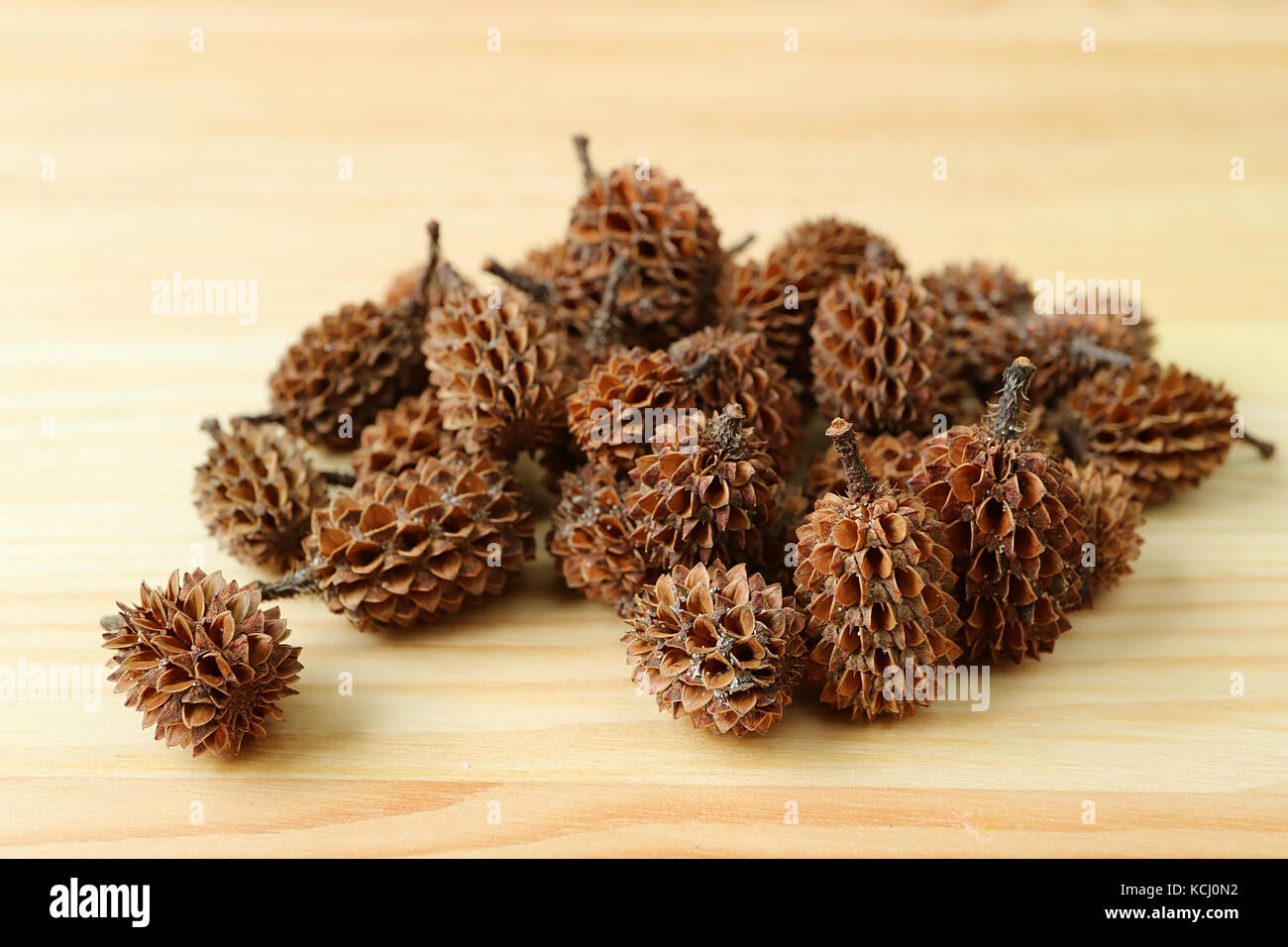 Pile Of Natural Dry Tiny Pine Cones On Light Brown Wooden Table Stock Photo Alamy
