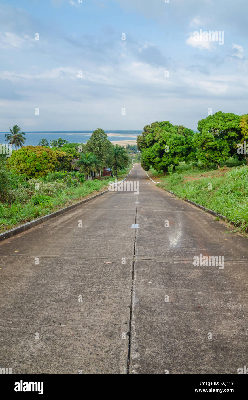 Concrete road leading down to the ocean in Robertsport, Liberia, West Africa Stock Photo