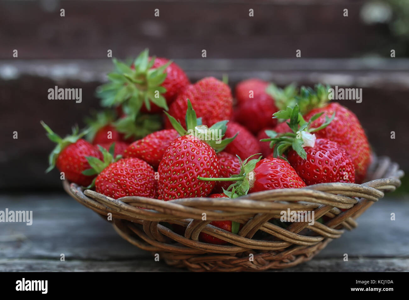 Strawberry on rustic wooden background Stock Photo - Alamy