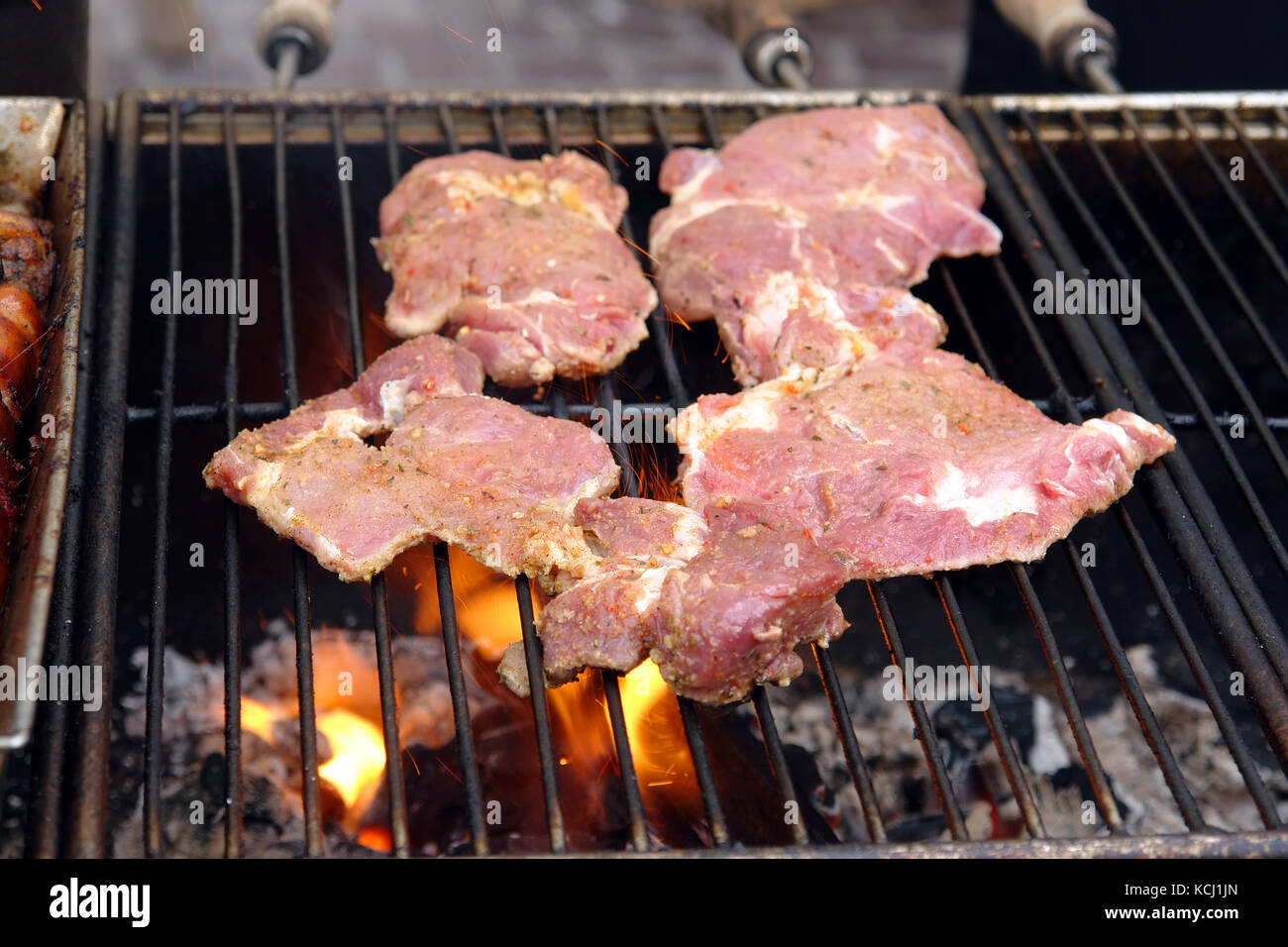 Red meat chops put on the barbecue set on fire Stock Photo