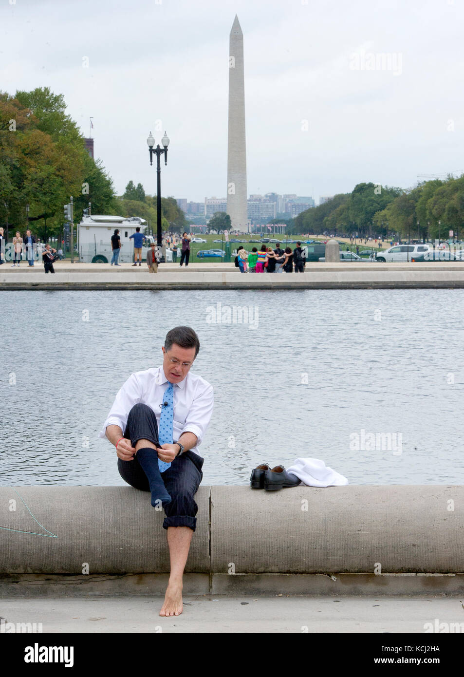 Stephen Colbert, host of the Comedy Central show 'The Colbert Report' puts his sox and shoes back on after working on a bit with United States Representative Jack Kingston (Democrat of Georgia) around the the U.S. Capitol Reflecting Pool in Washington, D.C. on Friday, October 3, 2014. Credit: Ron Sachs / CNP (RESTRICTION: NO New York or New Jersey Newspapers or newspapers within a 75 mile radius of New York City) /MediaPunch Stock Photo
