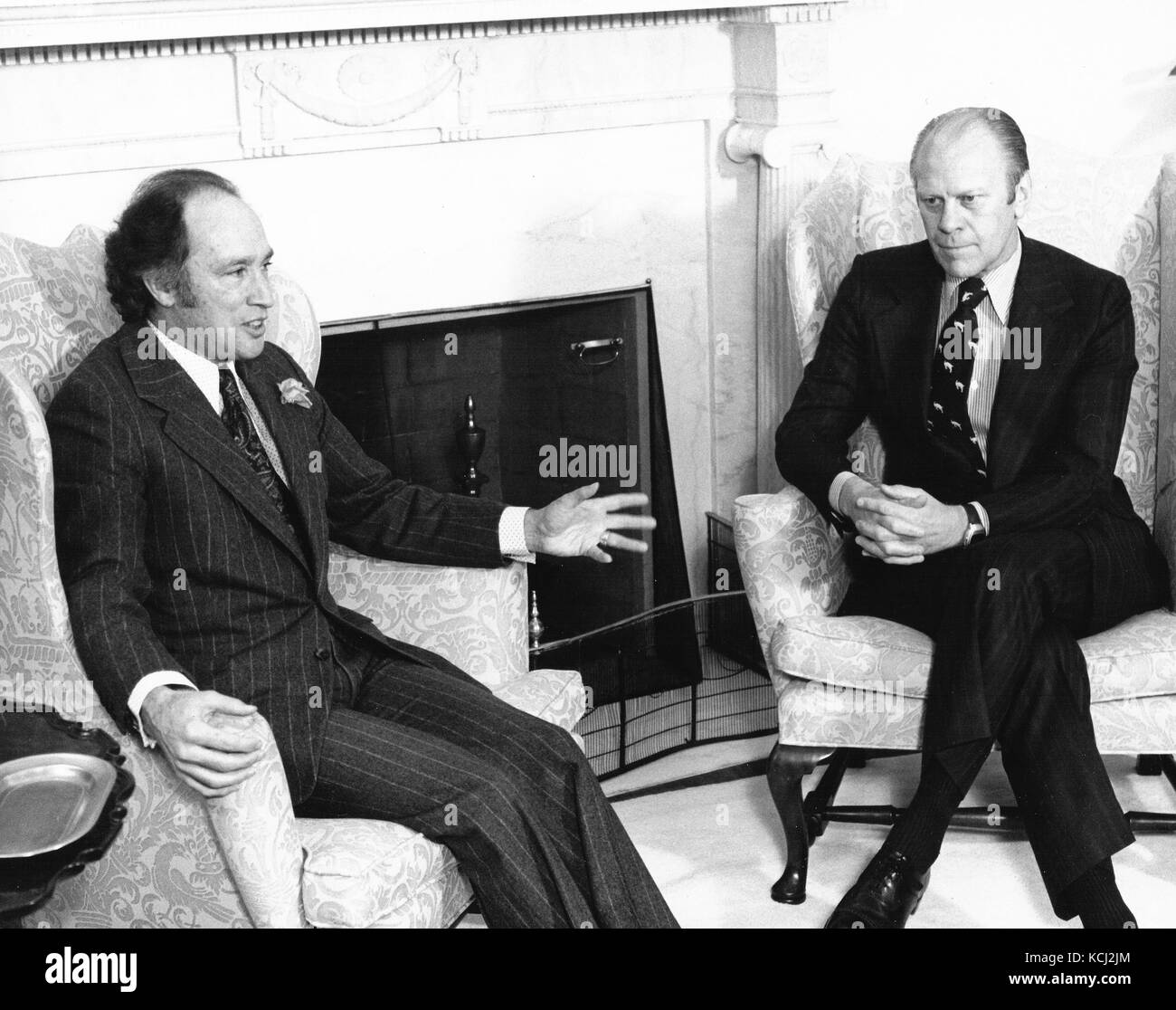 United States President Gerald R. Ford, right, meets Prime Minister Pierre Elliott Trudeau of Canada, left, in the Oval Office of the White House in Washington, DC on December 4, 1974.   The meeting was centered around oil and livestock.  Canada recently decided to phase out exports of oil to the US.  The US and Canada will still meet to resolve the dispute over Canada's ban on certain beef imports from the US.  The ban prompted the President to retaliate against Canadian meat imports. Credit: Barry A. Soorenko / CNP /MediaPunch Stock Photo
