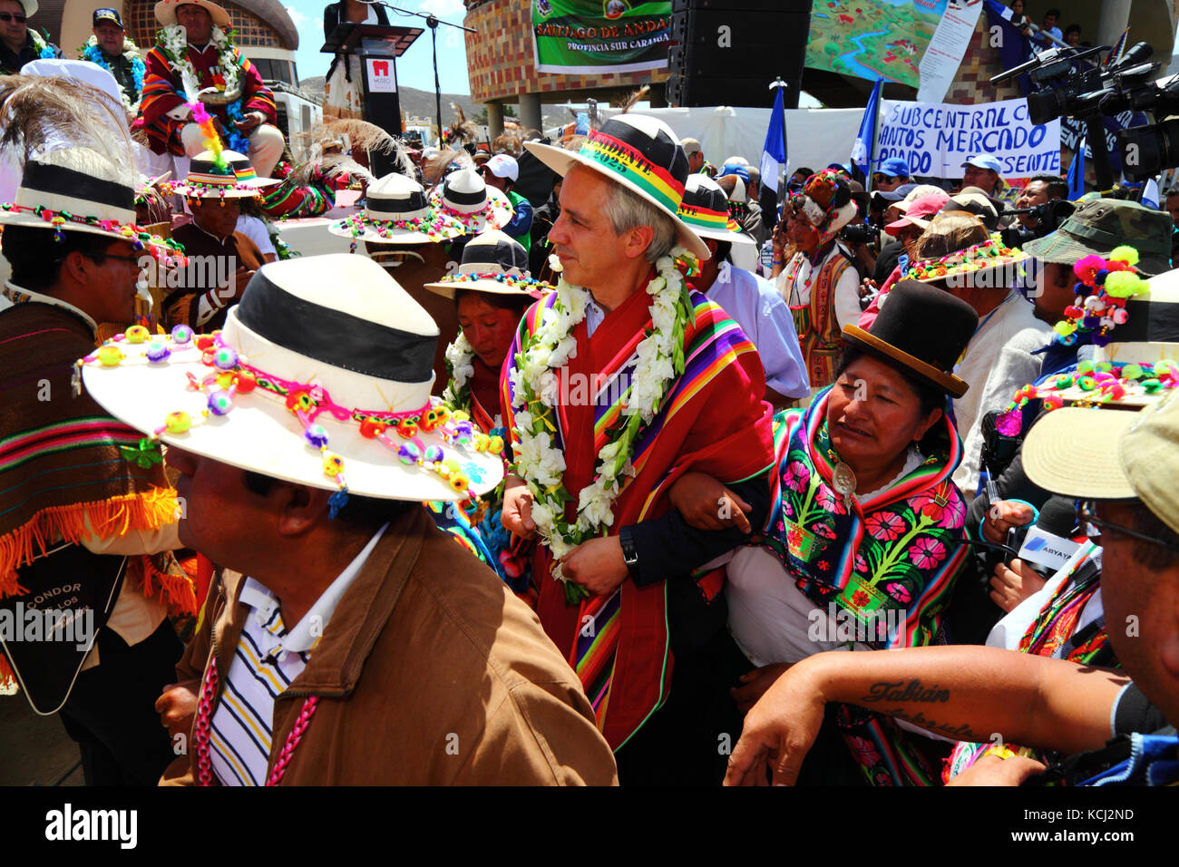 Bolivian vice president Alvaro Garcia Linera (centre) dances with indigenous supporters wearing traditional dress at political event, Orinoca, Bolivia Stock Photo