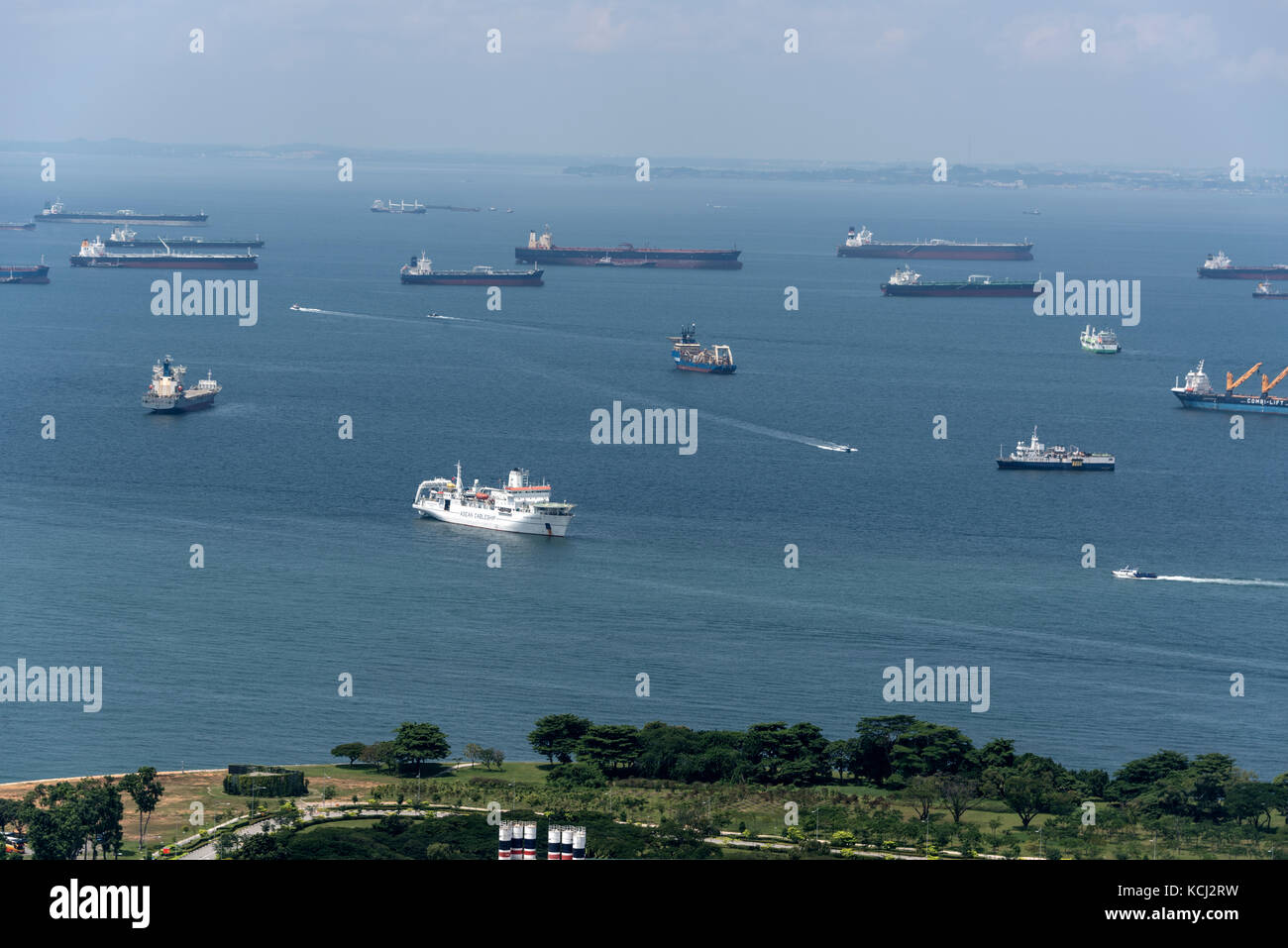 A fleet of cargo vessels moored off the coast in the Singapore Straits in Singapore.  The Port of Singapore is currently the world's second-busiest port Stock Photo