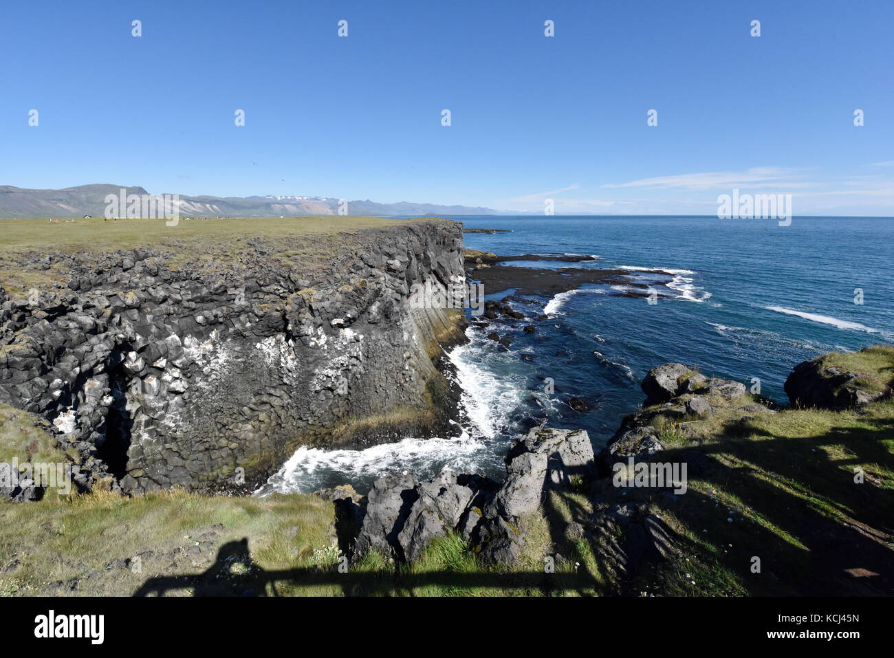 Shoreline and cliffs of basalt rock at Arnarstapi nature reserve seen ...