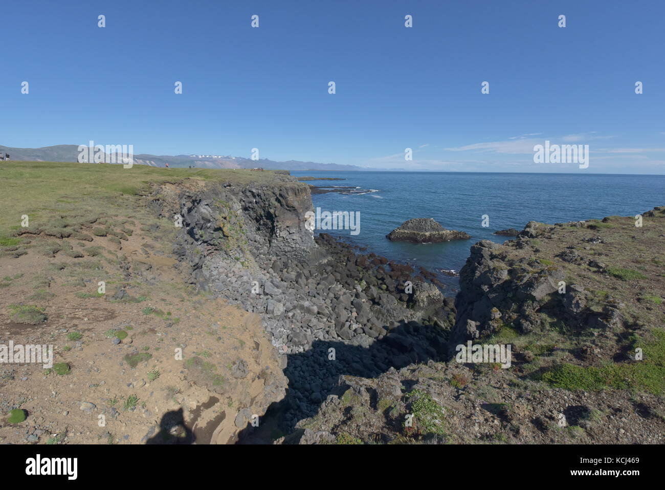 Shoreline and cliffs of basalt rock at Arnarstapi nature reserve seen ...