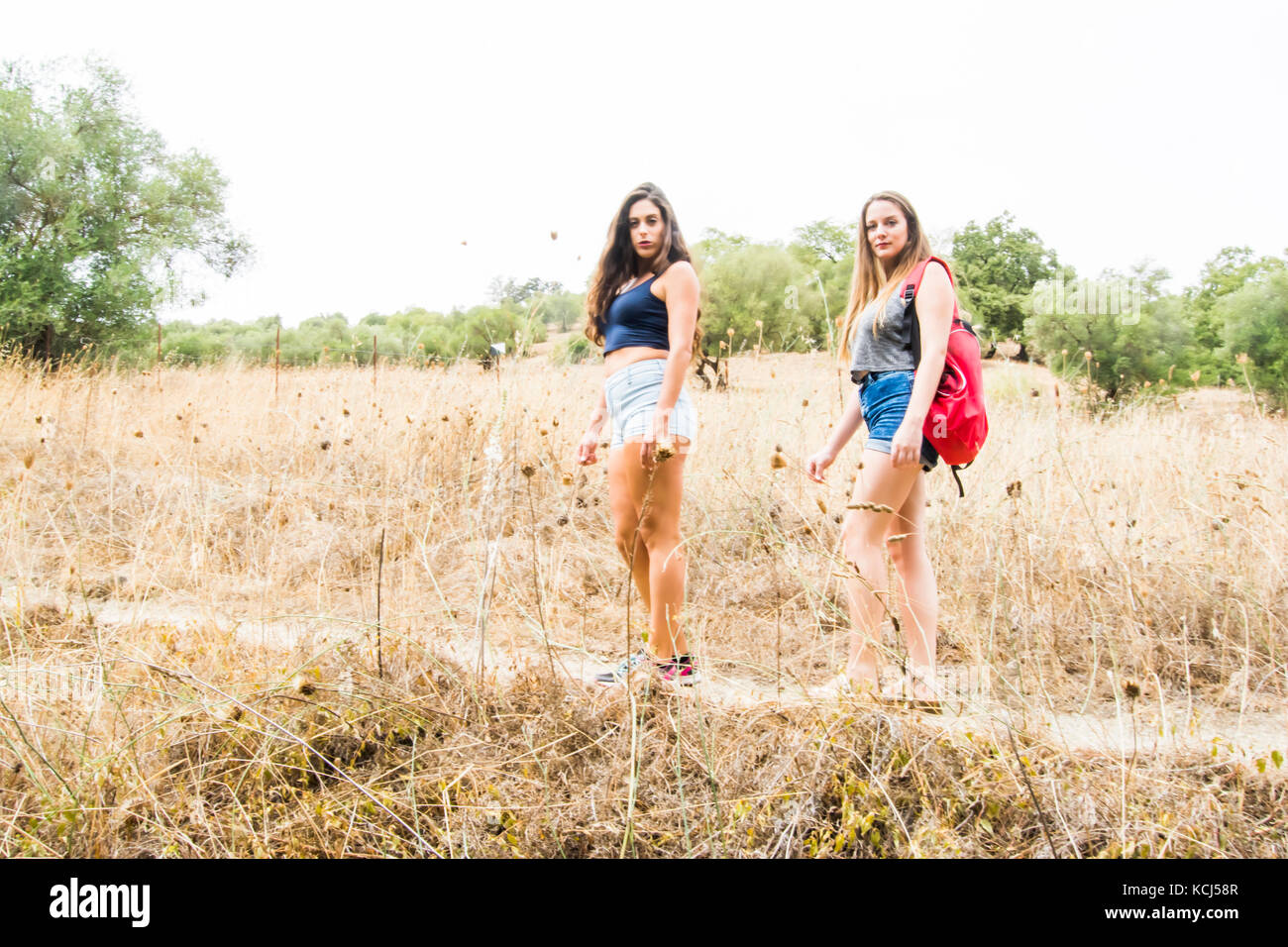Two beautiful women hiking in nature on a mountain road Stock Photo - Alamy