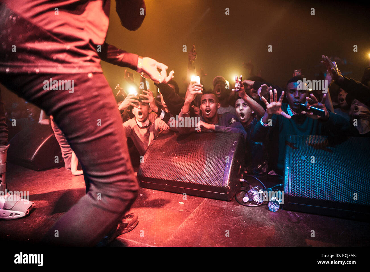 Energetic music fans and concert goers attend a live concert with the English hip hop and grime rap duo Krept and Konan at Pumpehuset in Copenhagen. Denmark, 05/12 2015. Stock Photo