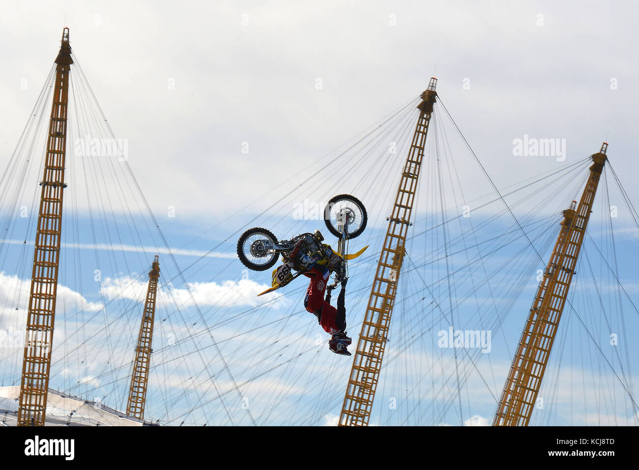 Nitro Circus ringleader and American professional motorsports competitor and stunt rider Travis Pastrana performs back-flips on a motorcycle between two floating barges in the River Thames, London, ahead of the opening at the Birmingham Arena in November of 'Nitro Circus: You Got This', which will visit 10 cities in six countries across the continent. Stock Photo
