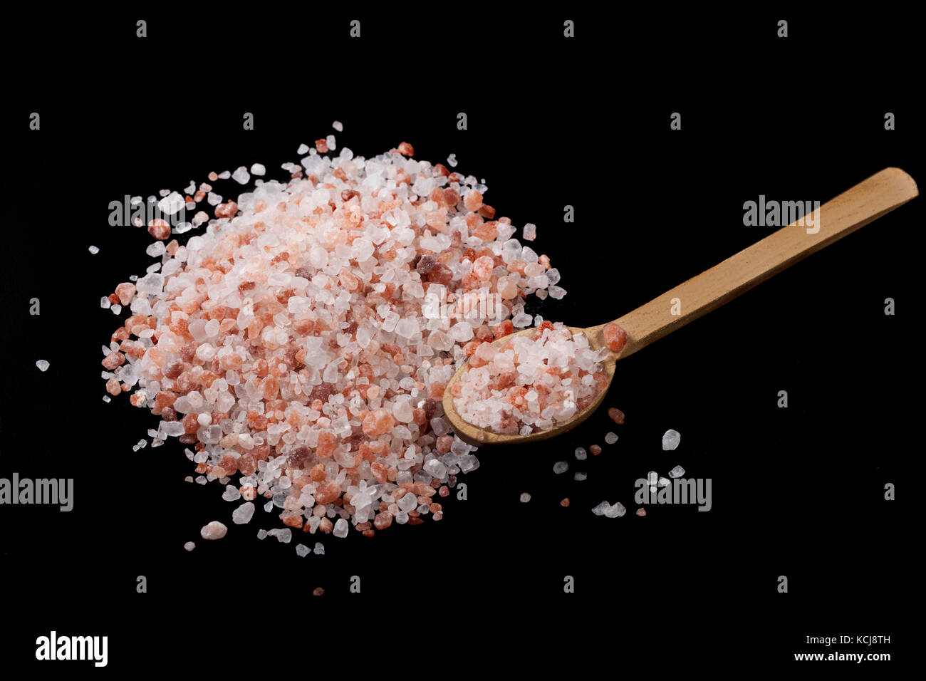 Himalayan Salt Heap With Wood Spoon on Black Background Stock Photo - Alamy