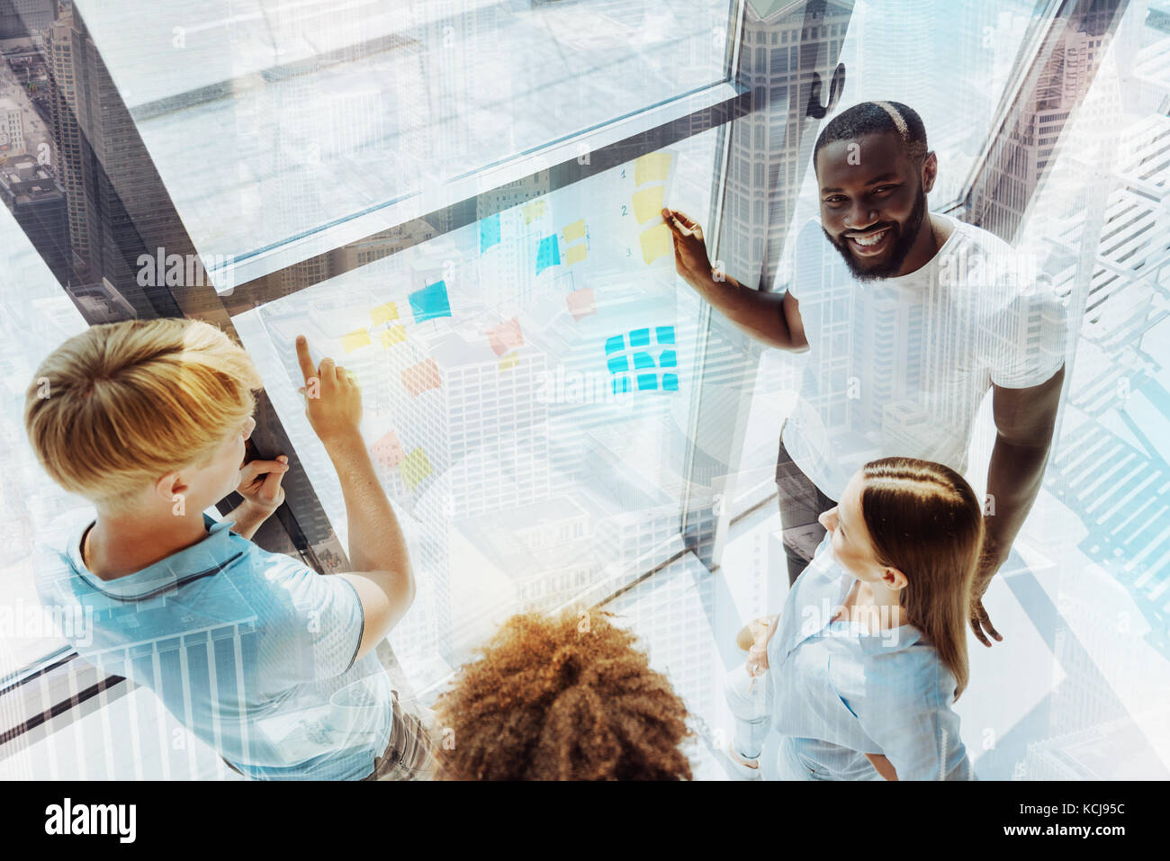 Bright pleasant colleagues working together Stock Photo - Alamy