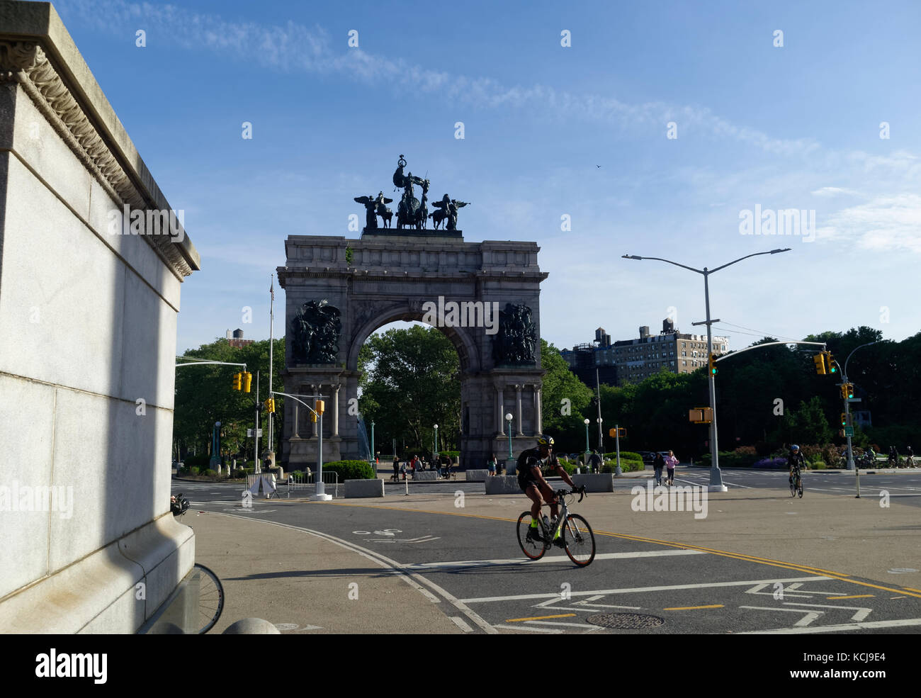 Pedestrians and cyclists at the Grand Army Plaza monument by Prospect Park. Stock Photo