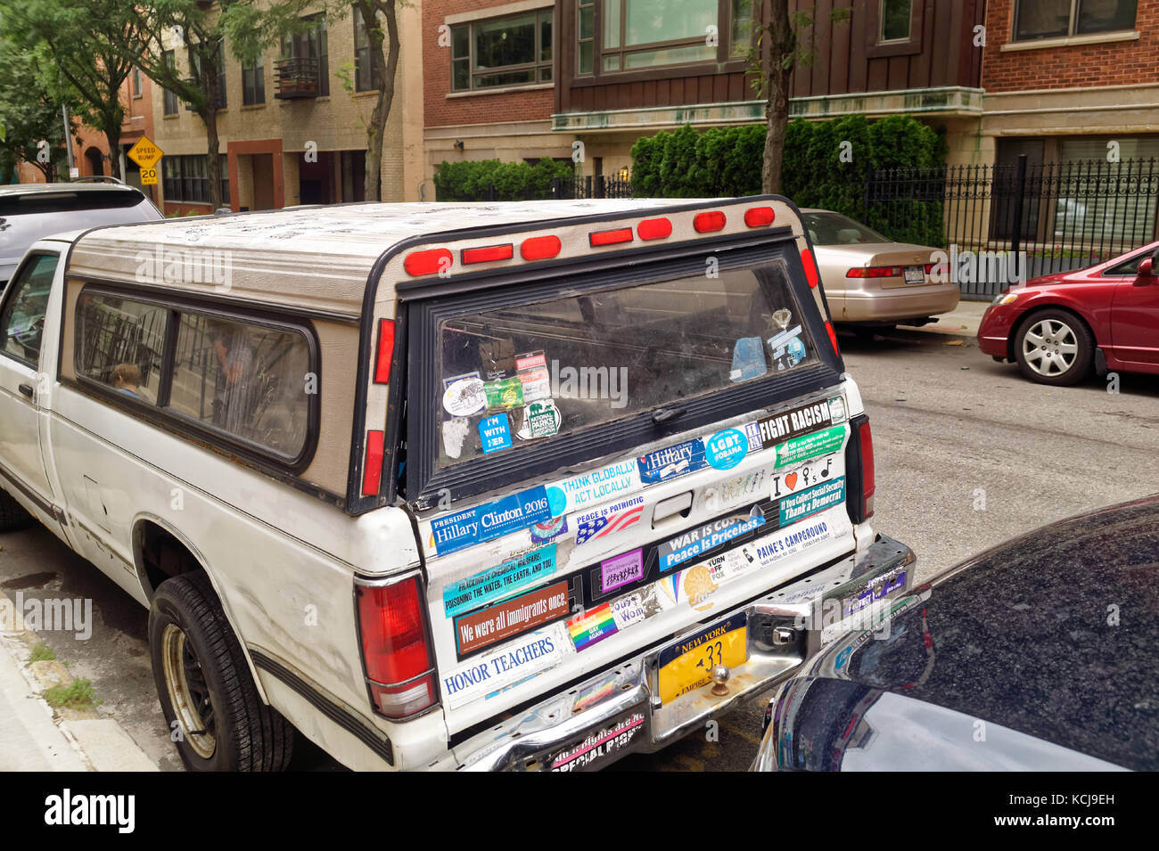 Leftie parked truck covered in protest stickers representing various causes. Stock Photo