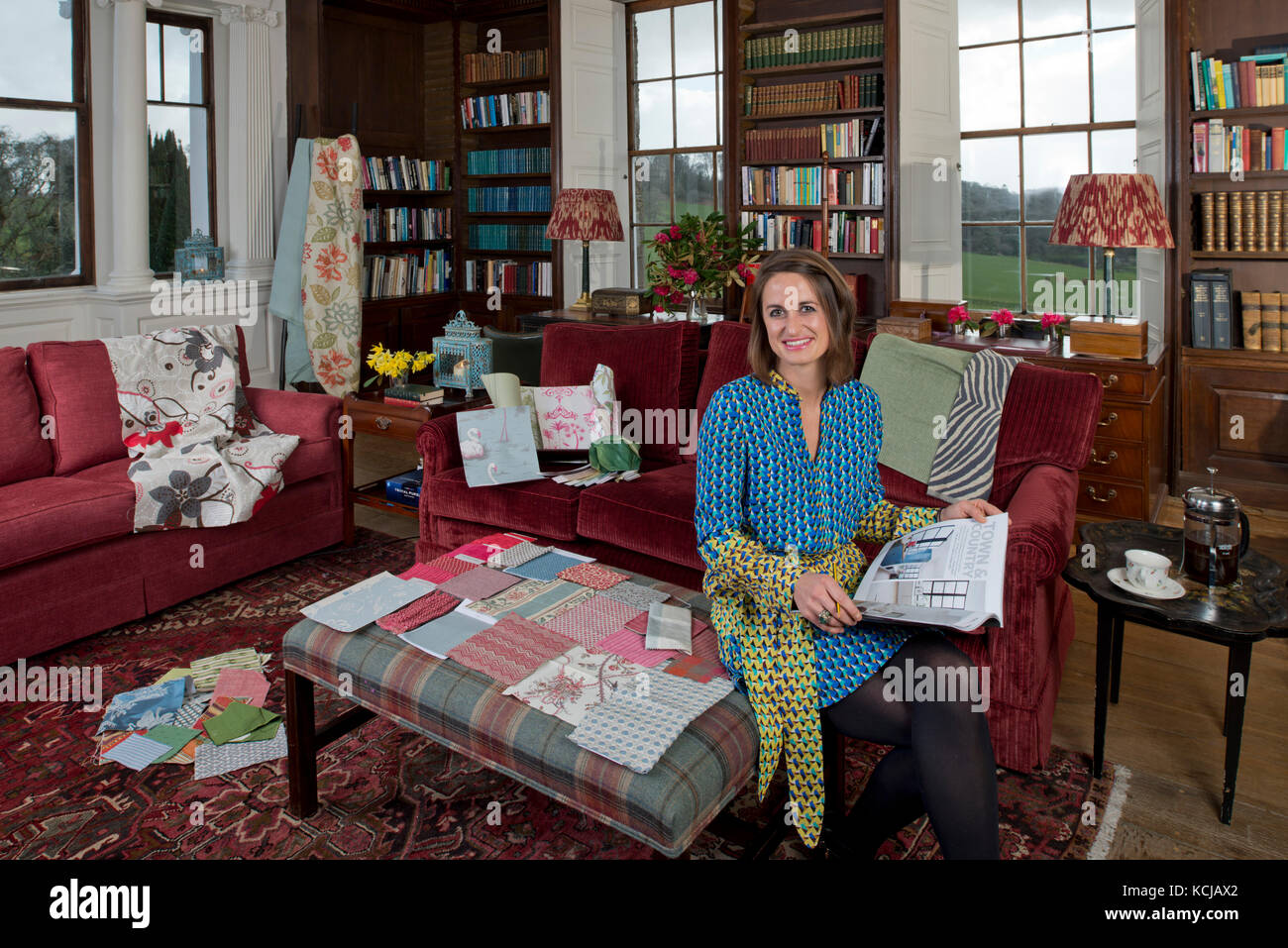 Interior Designer, Sarah Fortescue in her office, the library of Boconnoc House, Cornwall, the family home. Stock Photo