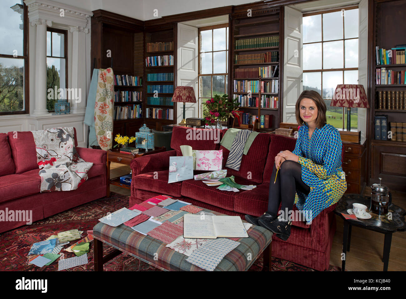 Interior Designer, Sarah Fortescue in her office, the library of Boconnoc House, Cornwall, the family home. Stock Photo