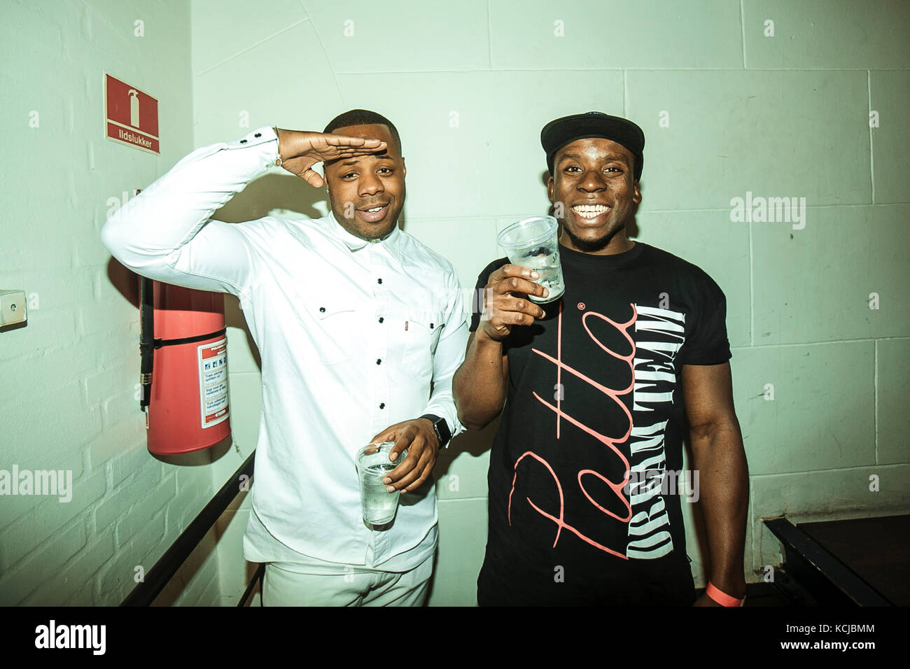 DJ Abstract (R) and MR. V.I (L) of the Dutch DJ and MC collective Patta SoundSystem are seen backstage before a live concert at Pumpehuset in Copenhagen. Denmark, 05/12 2015. Stock Photo